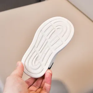 Detail view of anti-slip white rubber sole with size 22 engraving for kids shoes