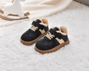 Detail of warm black kids' winter boots with khaki faux fur lining and velcro strap