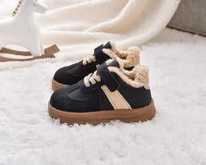Detailed close-up of warm faux shearling lining and thick brown rubber sole on kids boots