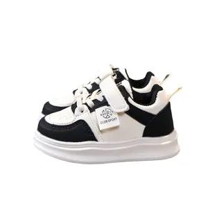 Kids warm fleece-lined sneakers in black and white leather with velcro and lace-up closure