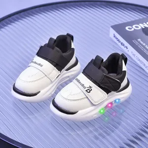 Sneakers LED per bambini bianche e nere con suola luminosa e cinturino in velcro