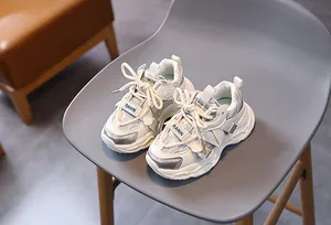 Detail showing white and silver mesh upper and non-slip sole of kids chunky sneakers