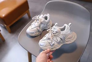 Detail of mesh and leather kids sneakers with hook-and-loop closure and thick non-slip soles