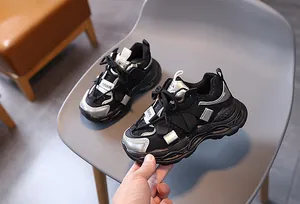 Detail view of children mesh sneakers showing synthetic leather layers and rubber sole
