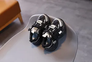 Detail view of black and silver mesh children sneakers with modern synthetic overlays