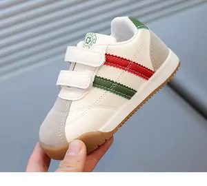 Detailed shot of white children's sneakers featuring dual velcro and non-slip gum sole
