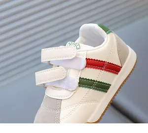 Detail view of water-resistant synthetic leather upper with hook-and-loop straps and rubber sole