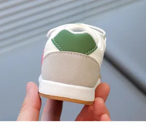 Close-up of kids leather sneaker heel with high-quality stitching and green color detail