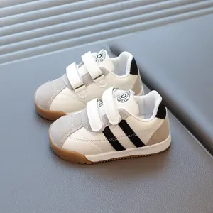 White leather toddler sneakers with grey suede toe and non-slip rubber sole