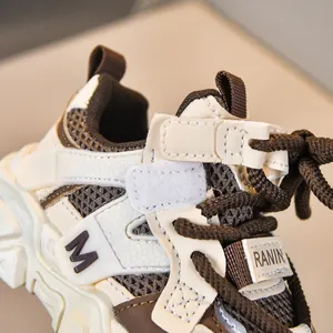 Detalle de zapatillas transpirables para niños con velcro y costuras marrones en contraste