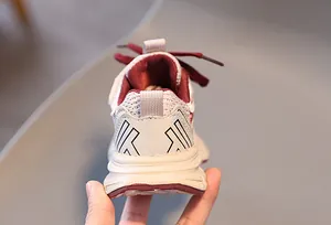 Gros plan sur le talon d'une chaussure de sport enfant en mesh respirant et bordeaux