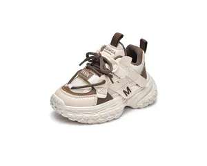 Detail of children's chunky sneakers featuring breathable mesh and brown leather accents