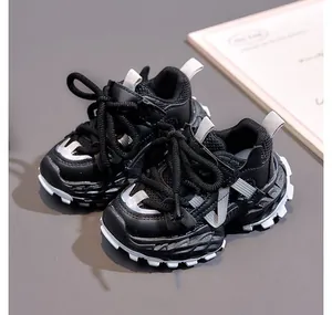 Detail of kids black chunky sneakers showing breathable mesh and non-slip soles