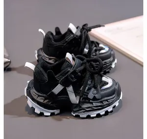 Close-up of kids black chunky sneakers showing breathable mesh and thick anti-slip soles