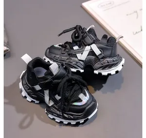 Detail of kids chunky sneakers featuring black mesh panels and iridescent holographic accents