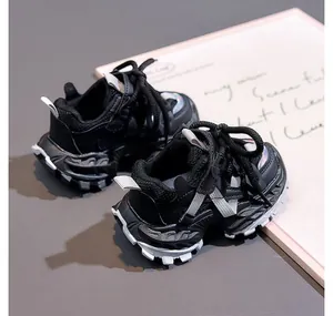 Close-up of kids black chunky sneakers showing breathable mesh and non-slip thick sole