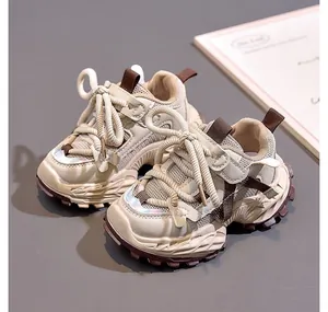 Detail of kids' beige chunky sneakers showing breathable mesh and anti-slip thick soles