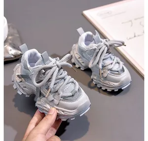 Detail of light grey kids sneakers with breathable mesh and anti-slip thick soles