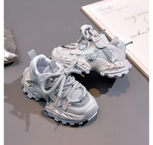 Detailed side view of breathable mesh and thick rubber sole on gray-blue kids sneakers