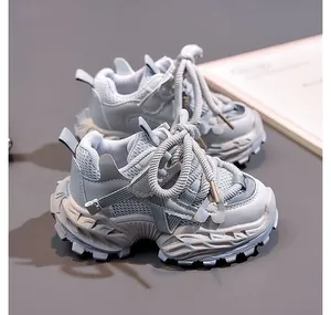 Close-up of kids mesh sneakers with thick textured midsoles and woven rope laces