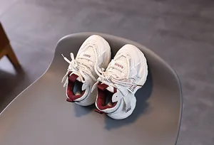 Close-up of boys mesh athletic shoes with leather stitching and soft anti-slip soles