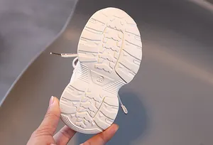 Detailed view of white anti-slip rubber outsole with size 23 marking for kids sneakers