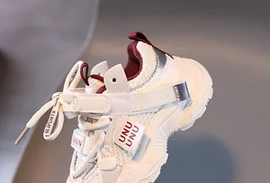 Close-up of kids mesh sneakers showing the breathable heel and red lining detail