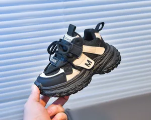 Close-up of children's sneakers with breathable mesh, thick rubber sole, and side M detail