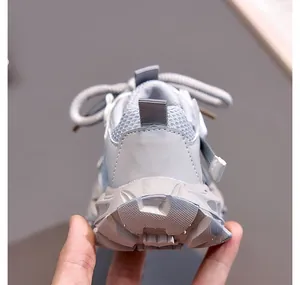Detail of grey kids chunky sneakers with breathable mesh and anti-slip thick sole