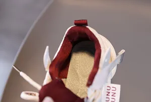Macro view of breathable burgundy mesh lining and honeycomb insole in kids' sneakers