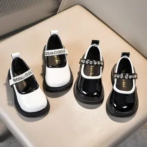 Makro-Detail von glänzenden Lackleder-Mary-Janes für Mädchen mit funkelnden Strasssteinen
