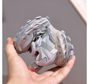 Close-up of flexible non-slip rubber sole for children sports shoes being bent by hand