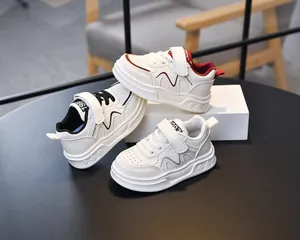 Detailed view of children's leather sneakers with velcro straps and anti-slip soft soles