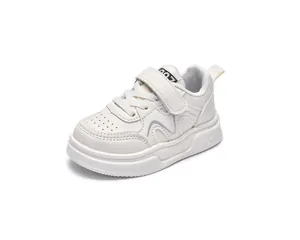 Detailed close-up of beige kids sneakers with breathable leather upper and velcro strap