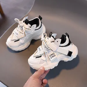 Kids chunky sneakers in white and black mesh with non-slip soles and velcro straps
