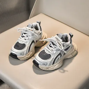 Close-up of children's mesh sneakers with silver leather panels and chunky soles