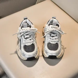 Detailed top view of breathable mesh and faux leather paneling on children's retro sneakers