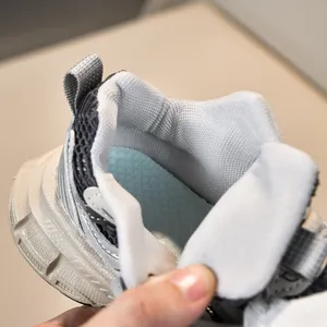 Close-up of breathable mesh upper and soft padded lining on children sneakers