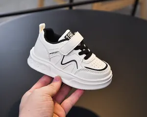 Detailed macro view of white children sneaker with black laces and non-slip rubber sole
