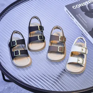 Multiple colors of classic buckle strap kids sandals displayed on a stylish glass table