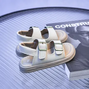 Detail view of cream children sandals with dual adjustable straps and retro metal buckles