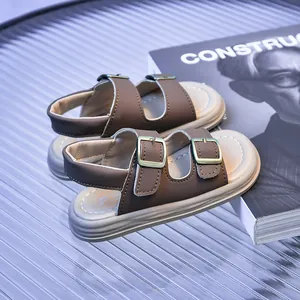 Detail view of brown toddler Birkenstock sandals with gold buckles on a stylish table
