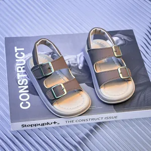 Detailed macro view of brown toddler sandals with brass buckles on a fashion magazine