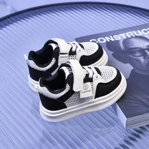 Detail of kids breathable mesh sneaker with velcro strap and black leather trim