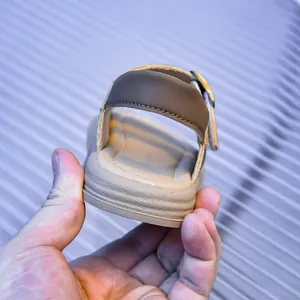 Detail view of toddler cork sandals featuring brown faux leather straps and velcro closure