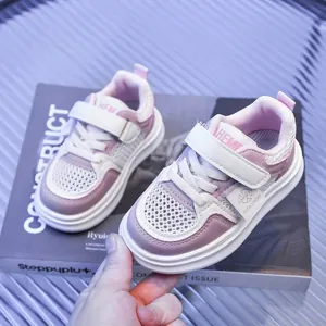 Detailed macro view of pink breathable mesh sneakers with adjustable velcro straps
