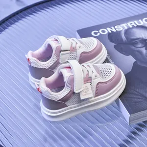 Detail of pink and white kids mesh sneakers with breathable fabric and velcro straps