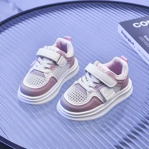 Detailed view of pink and white mesh kids' sneakers featuring breathable mesh and velcro straps