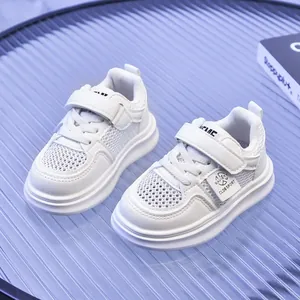 Close-up detail of white breathable mesh and synthetic leather on kids' sports sneakers