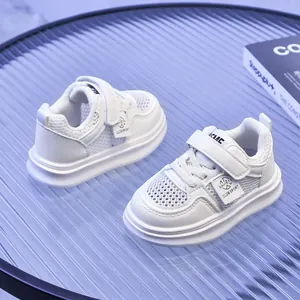 Close-up of kids white breathable mesh sneakers with velcro strap and chunky sole